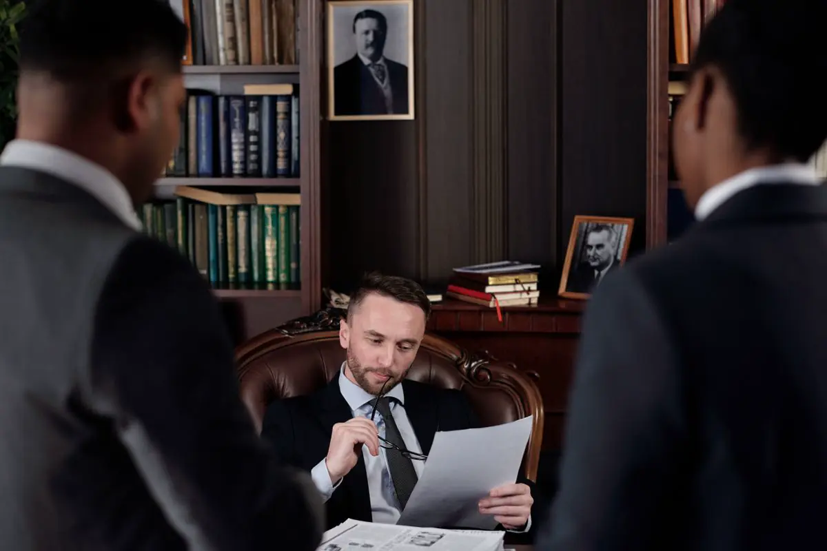 Legal professionals discussing documents in an office
